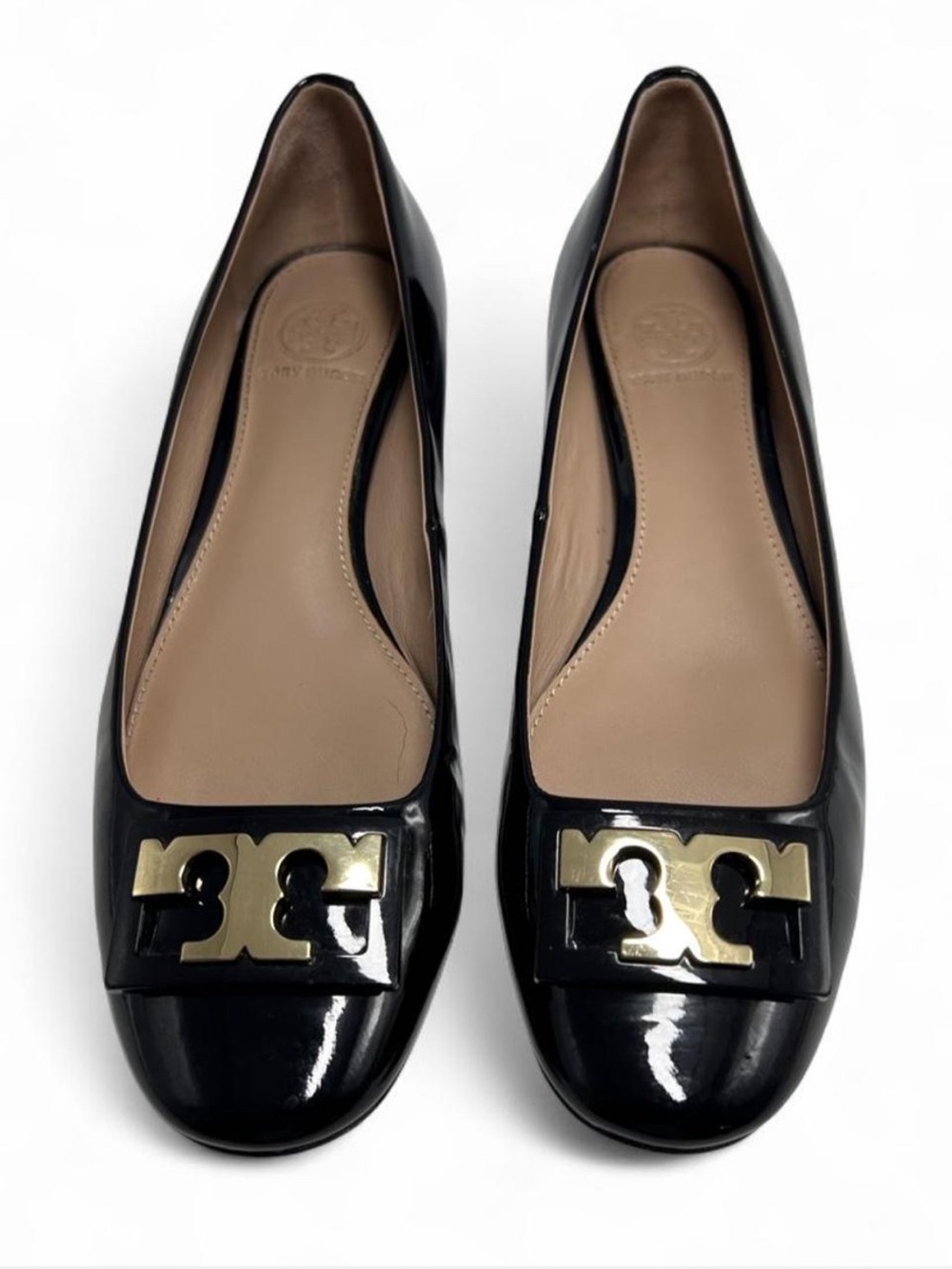 Tory Burch Gigi Pumps, glossy black patent leather, classic round toe, "T" logo.
